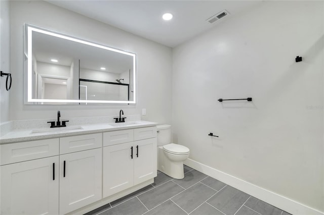 bathroom with walk in shower, vanity, and toilet