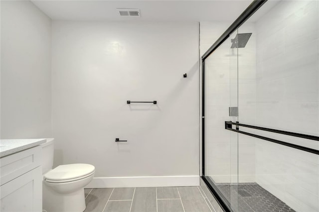 bathroom featuring vanity, toilet, and a shower with door