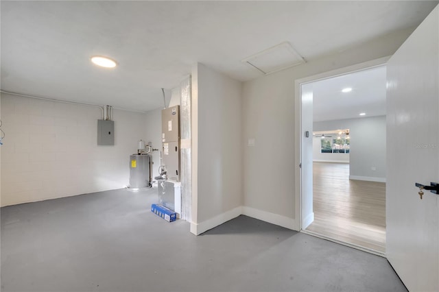 basement with heating unit, electric water heater, and electric panel