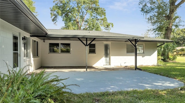 back of house with a lawn and a patio area