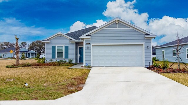 view of front of property featuring a front yard and a garage