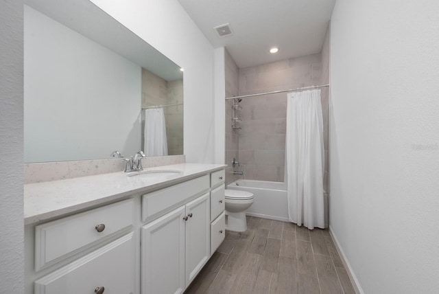 full bathroom featuring wood-type flooring, vanity, toilet, and shower / bathtub combination with curtain