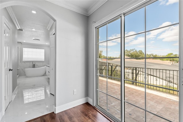 doorway with crown molding, a textured ceiling, and dark hardwood / wood-style floors