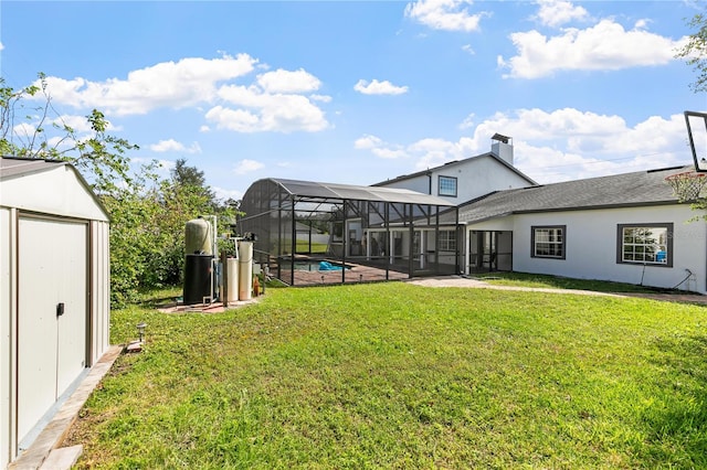 view of yard with a patio, a storage unit, and a lanai