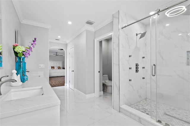 bathroom with an enclosed shower, toilet, ceiling fan, vanity, and crown molding