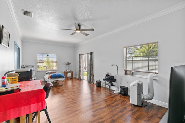 office featuring dark wood-type flooring, crown molding, a textured ceiling, and ceiling fan