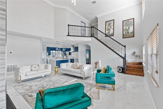 living room with crown molding and a high ceiling