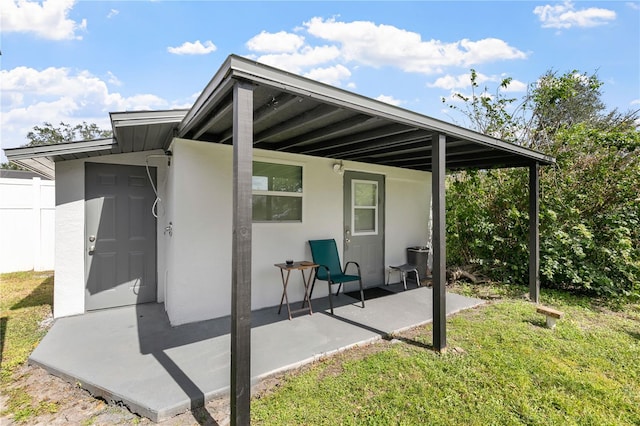 exterior space featuring a patio area and a lawn