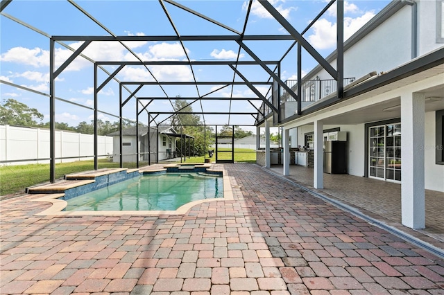 view of swimming pool with a patio and glass enclosure