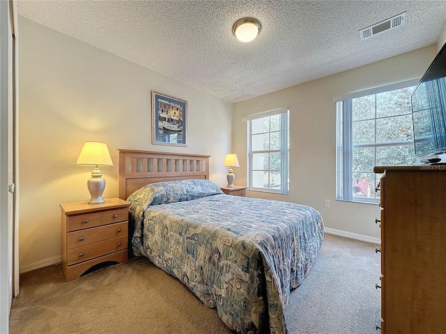 carpeted bedroom featuring a textured ceiling