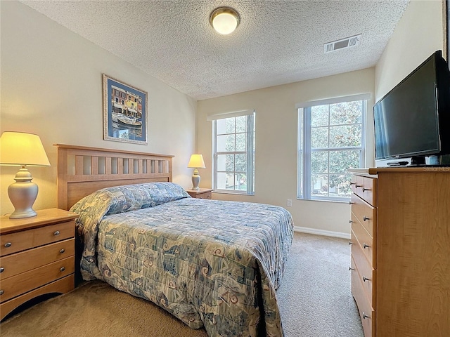 carpeted bedroom featuring a textured ceiling