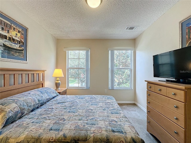 carpeted bedroom with a textured ceiling