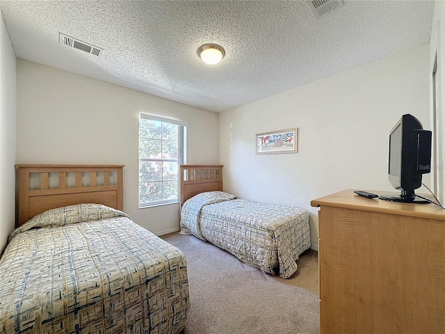 carpeted bedroom featuring a textured ceiling