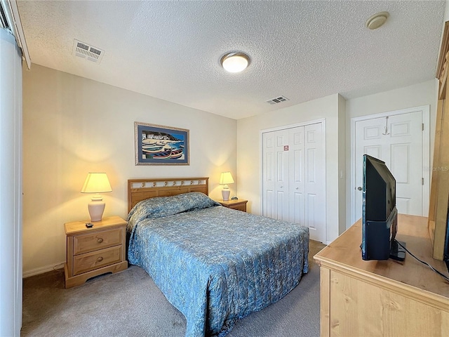 carpeted bedroom featuring a textured ceiling