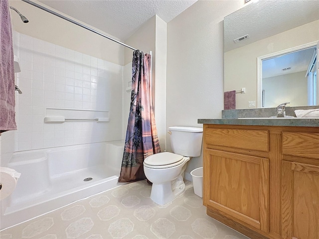 bathroom featuring vanity, a textured ceiling, toilet, and walk in shower