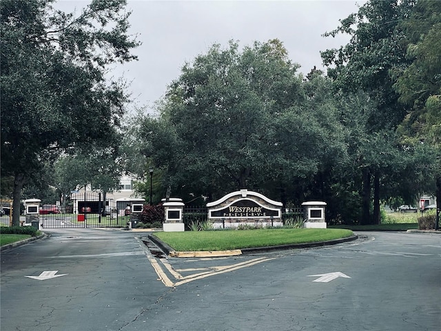 view of road with curbs and a gated entry