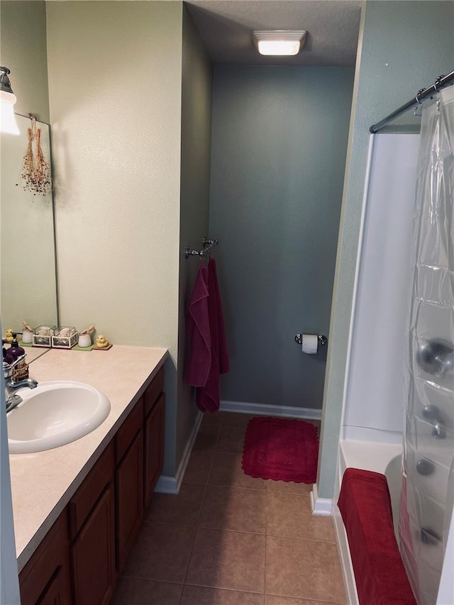 bathroom featuring shower / bath combo, tile patterned flooring, vanity, and a textured ceiling