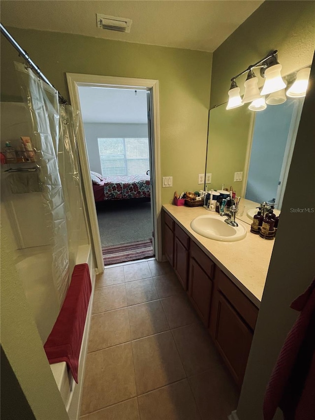 bathroom with shower / bathtub combination with curtain, tile patterned floors, and vanity