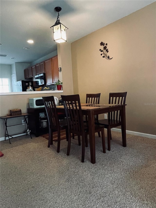 view of carpeted dining area