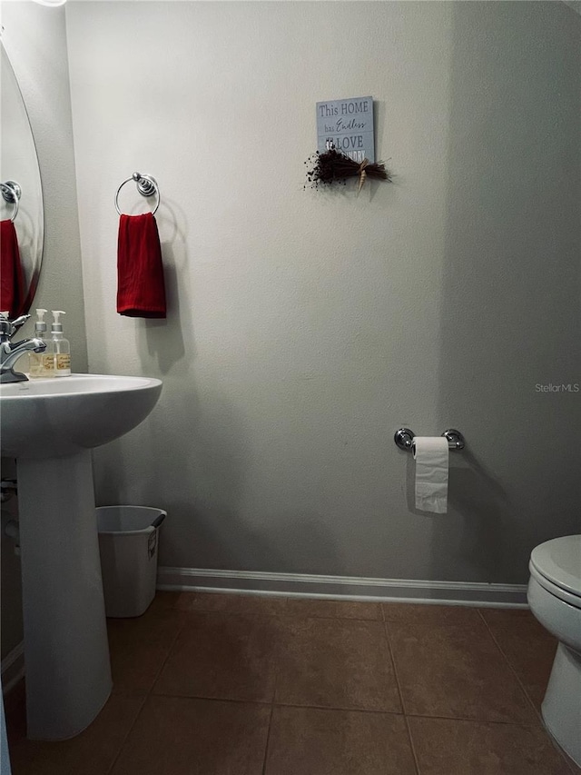 bathroom with tile patterned flooring and toilet