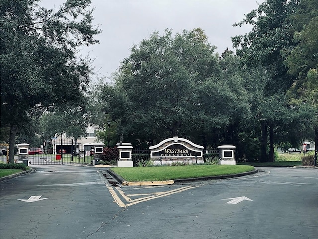 10453 Westpark Preserve Blvd, Tampa, FL 33625 - view of asphalt street with curbs, street lighting, a gated entry, and a gate
