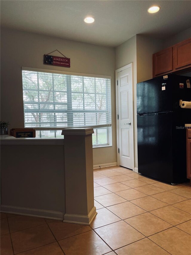 10453 Westpark Preserve Blvd, Tampa, FL 33625 - kitchen featuring freestanding refrigerator, light tile patterned flooring, recessed lighting, baseboards, and brown cabinetry