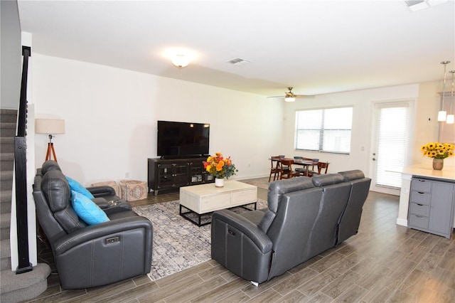 living room with hardwood / wood-style floors and ceiling fan