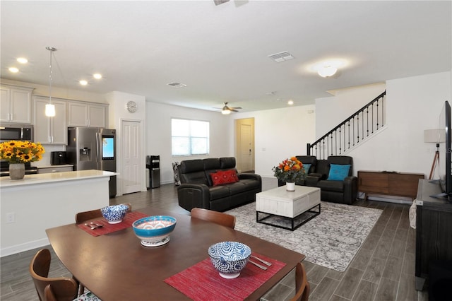 living room with ceiling fan and dark hardwood / wood-style flooring