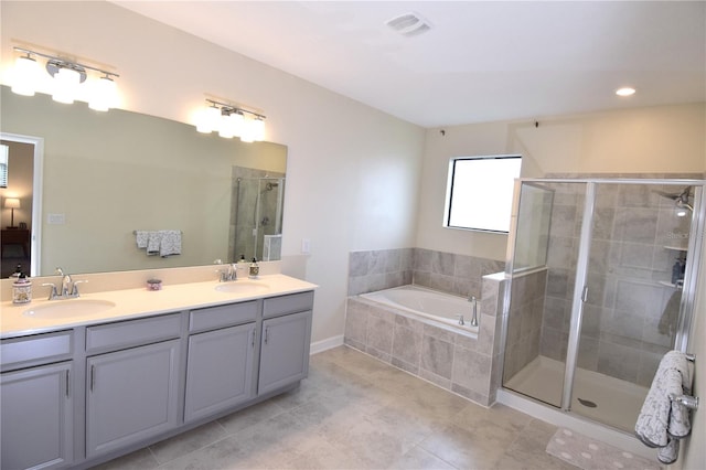 bathroom featuring vanity, shower with separate bathtub, and tile patterned flooring