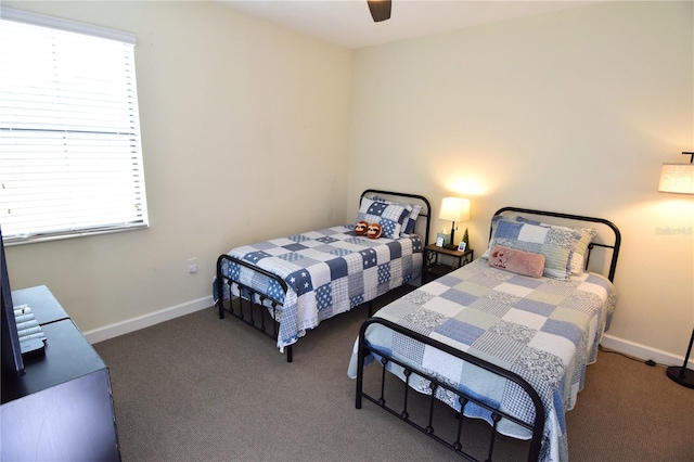 bedroom featuring ceiling fan and dark carpet