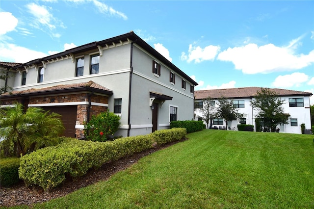 view of property exterior with a yard and a garage