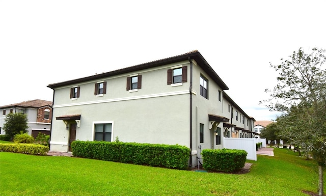 rear view of house featuring a yard