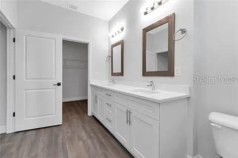 bathroom featuring hardwood / wood-style flooring, toilet, and vanity