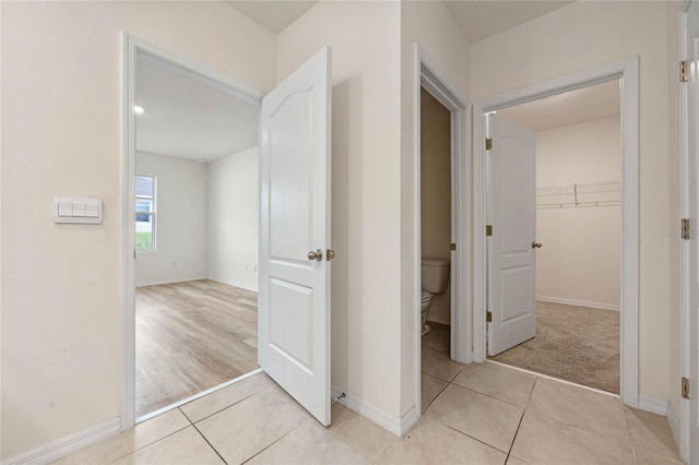 hall featuring light tile patterned floors