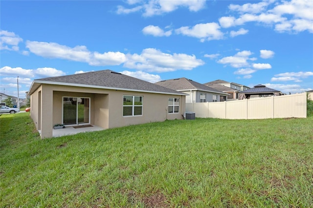 rear view of house with a yard