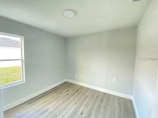 empty room with light hardwood / wood-style flooring