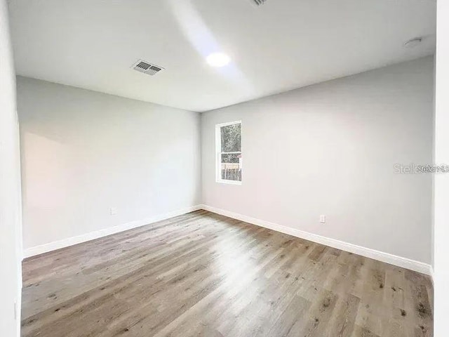 unfurnished room with light hardwood / wood-style floors