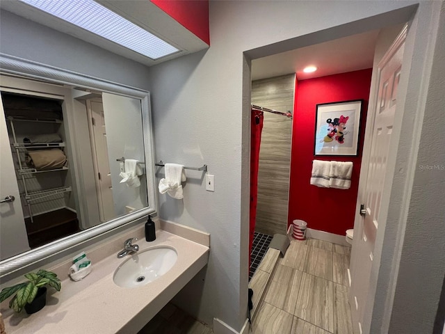 bathroom with sink and a shower with shower curtain