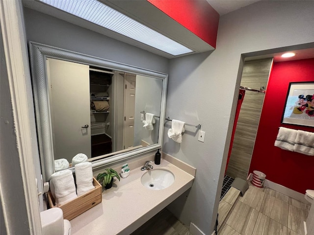 bathroom featuring a shower, sink, and toilet