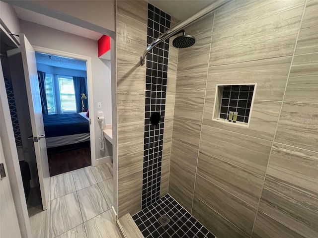 bathroom with tiled shower