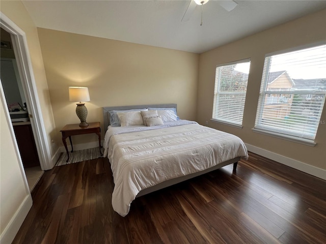 bedroom with ceiling fan and dark wood-type flooring