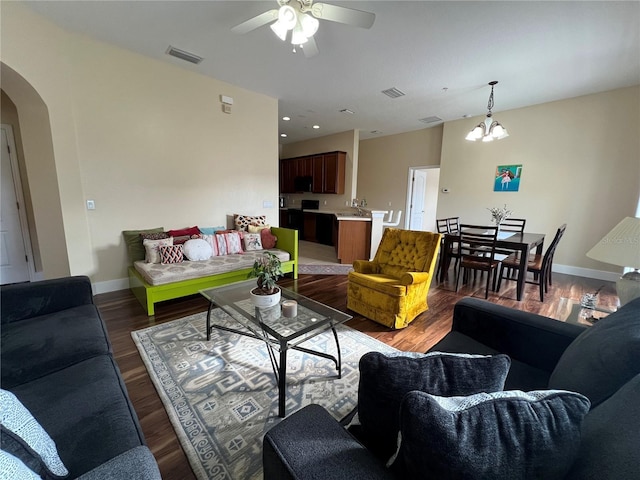 10791 Gran Paradiso Dr Unit S, Orlando, FL 32832 - living area with a ceiling fan, arched walkways, wood finished floors, a chandelier, and baseboards