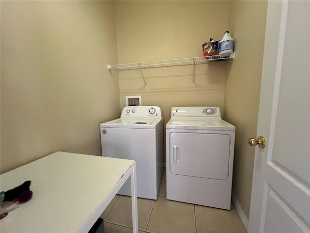 washroom featuring separate washer and dryer and light tile patterned flooring