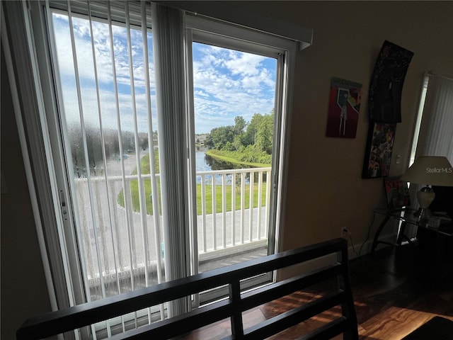 interior space with hardwood / wood-style flooring and a water view