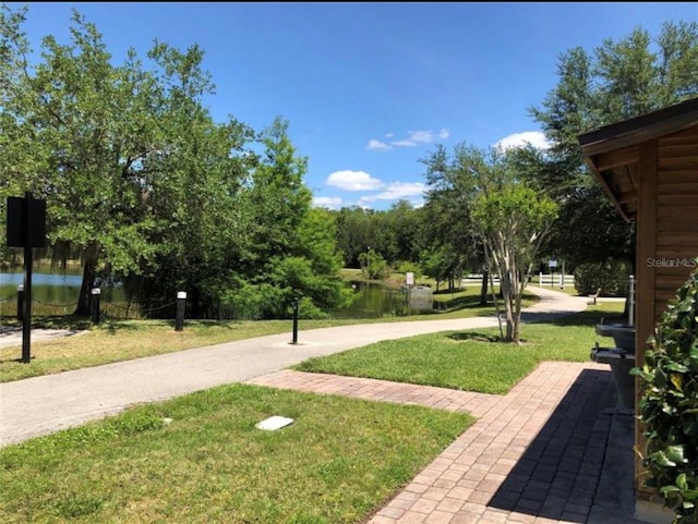 surrounding community featuring a yard and a water view