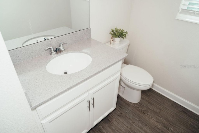 bathroom featuring hardwood / wood-style flooring, vanity, and toilet