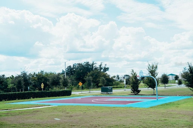 view of basketball court with a yard