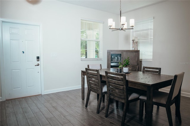 dining room featuring hardwood / wood-style floors and a notable chandelier