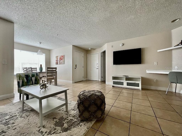 tiled living room featuring a textured ceiling