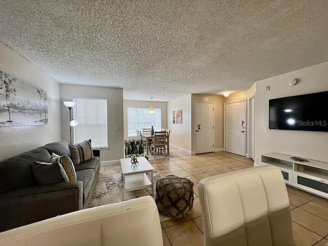 tiled living room featuring a textured ceiling